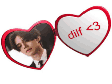 a red heart shaped mirror with a picture of a man and the words dilf < 3