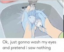 a person is washing their eyes in a sink while wearing blue gloves .