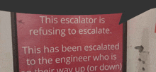 a sign that says " this escalator is refusing to escalate "