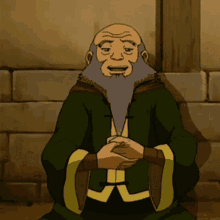 a cartoon man with a beard is sitting in front of a brick wall with his hands folded .