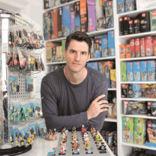 a man is standing in front of a display of lego bricks