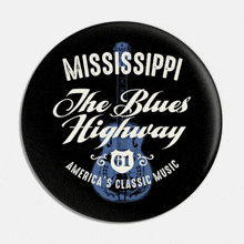 a mississippi the blues highway button with a guitar on it