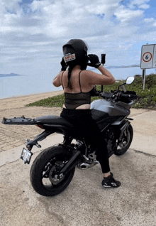 a woman wearing a helmet with a sticker on it that says " i am a biker "