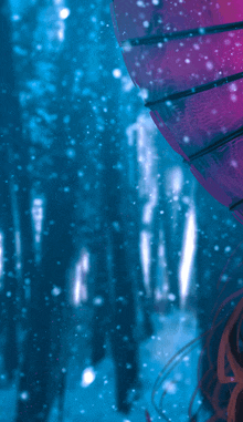 a purple umbrella is floating in the air with a blue background