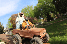 a toy jeep with two zombies riding in it