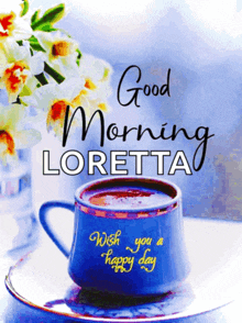 a blue cup of coffee sits on a saucer with the words good morning loretta