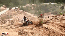 a man riding a four wheeler on a dirt road with a logo for orci atv riders on the bottom