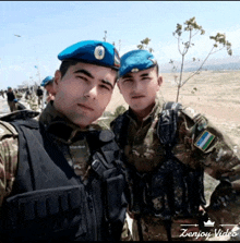 two soldiers are posing for a picture with a zenjoy video logo in the corner