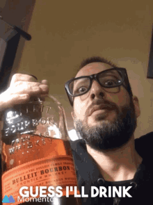 a man holds a bottle of bulleit bourbon whiskey