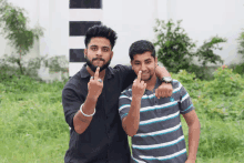 two young men are giving the middle finger