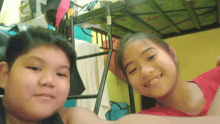 a boy and a girl pose for a picture in a bunk bed