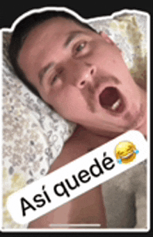 a man is laying in bed with his mouth open and a sticker that says ' asi quede ' on it