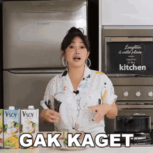 a woman in front of a sign that says " laughter and wild plants come together in this kitchen "