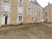 a large stone building with a few windows and a door