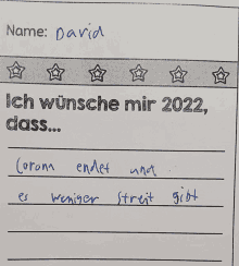 a paper that says ich wünsche mir 2022 dass corona endet und es weniger streit gibt