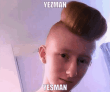 a young man with a big bun on his head has the name yezman on his face .