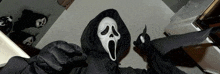 a person wearing a scream mask and holding a knife