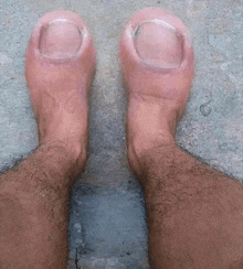 a man 's feet with very long nails and a hairy leg