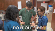 a group of doctors and nurses standing in a room with the words do it outside written on the bottom