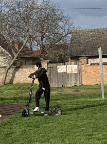 a person riding a scooter in a grassy area