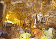 a cave with a lot of rocks and a light shining through the ceiling