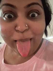 a woman making a funny face with her tongue sticking out