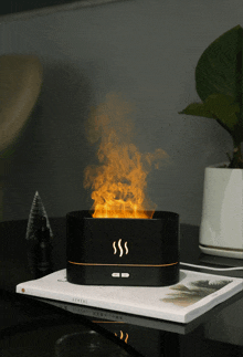 a black box with smoke coming out of it sits on a book called central