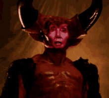 a man in a devil costume with horns and a red face