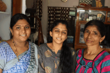 three women posing for a picture in a living room