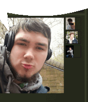 a young man wearing headphones takes a selfie