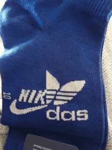 a pair of blue socks that say nike and adidas on them