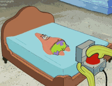 a cartoon of patrick star laying on a bed next to a button