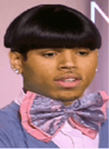 a young man with a bowl cut and a bow tie