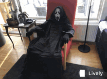 a person in a scream costume is sitting in a chair with a lively icon in the corner