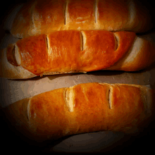 three loaves of bread are sitting on a table with holes in them