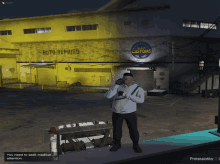 a man standing in front of a building that says auto repairs on it