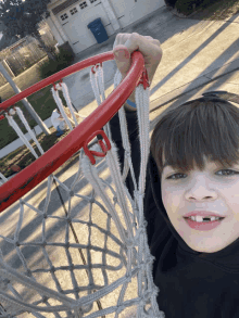 a young boy is holding a basketball hoop with the letter s on it