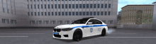 a white police car is parked in a parking lot