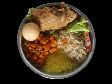 a plastic container filled with rice vegetables and a chicken head