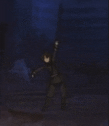 a person is holding a sword in the dark .