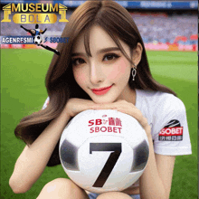 a girl is holding a soccer ball with the number 7 on it