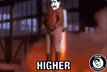 a man is standing in front of a fire with the words `` higher '' written on the screen .