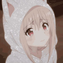 a girl with red eyes and a white hoodie with cat ears .