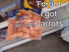 a bag of baby carrots in a refrigerator with the words forgot i got carrots