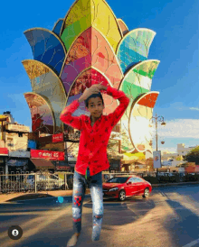 a boy in a red shirt is standing in front of a colorful building that says airtel 4g