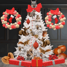 a white christmas tree with squirrels on it