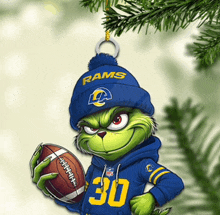 a grinch holding a football with the number 30 on his sweatshirt