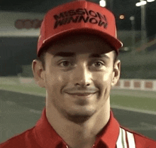 a man wearing a red hat and a red shirt is smiling for the camera .