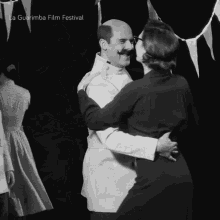 a black and white photo of a man and woman dancing with the words la guarimba film festival written above them