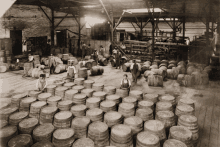 a black and white photo of barrels in a warehouse